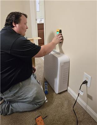 Vitacorps Installation Technician prepares to install wellness upgrades that will enhance indoor air quality.