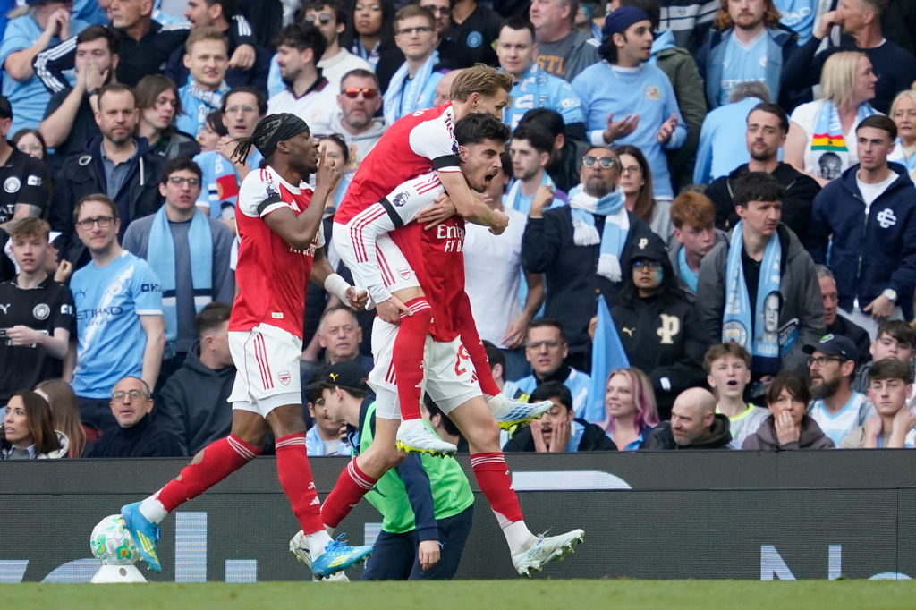 Arsenal's Kai Havertz celebrates with his teammates after scoring his side's first goal during the English Premier League soccer match between Manchester City and and Arsenal, in Manchester, England, Sunday, April 19, 2026. (AP Photo/Dave Thompson)
