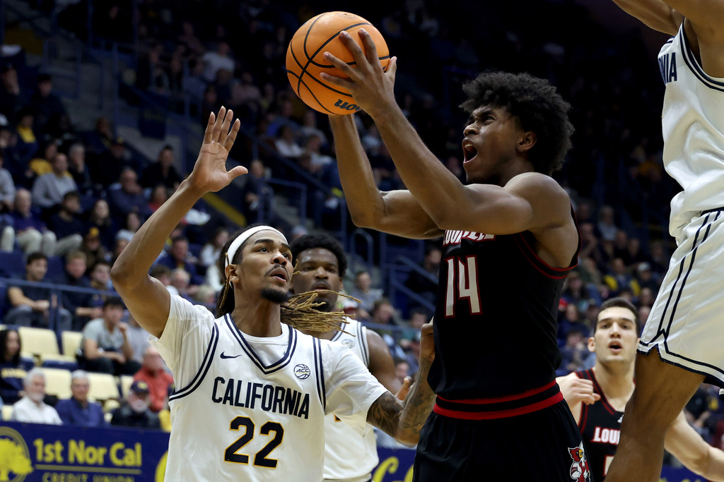Louisville guard Adrian Wooley (14) shoots against California forward Chris Bell (22) during the second half of an NCAA college basketball game in Berkeley, Calif., Tuesday, Dec. 30, 2025. (AP Photo/Jed Jacobsohn)
