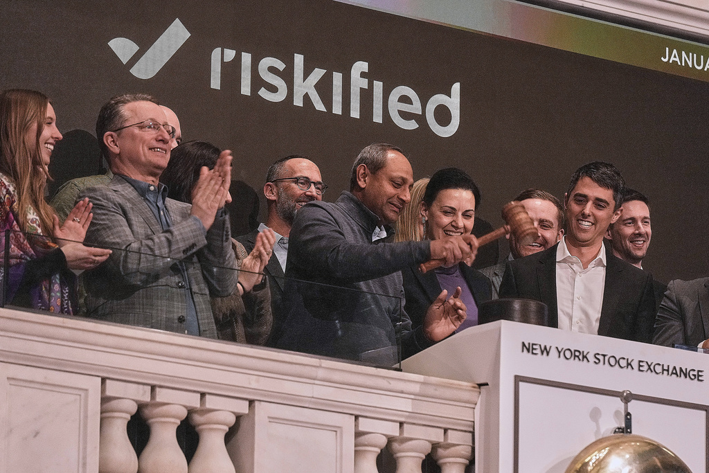 Ravi Kumaraswami, center, Riskified President of Worldwide Field Operations., gavels trading closed at the New York Stock Exchange, Monday, Jan. 12, 2026. (AP Photo/Richard Drew)