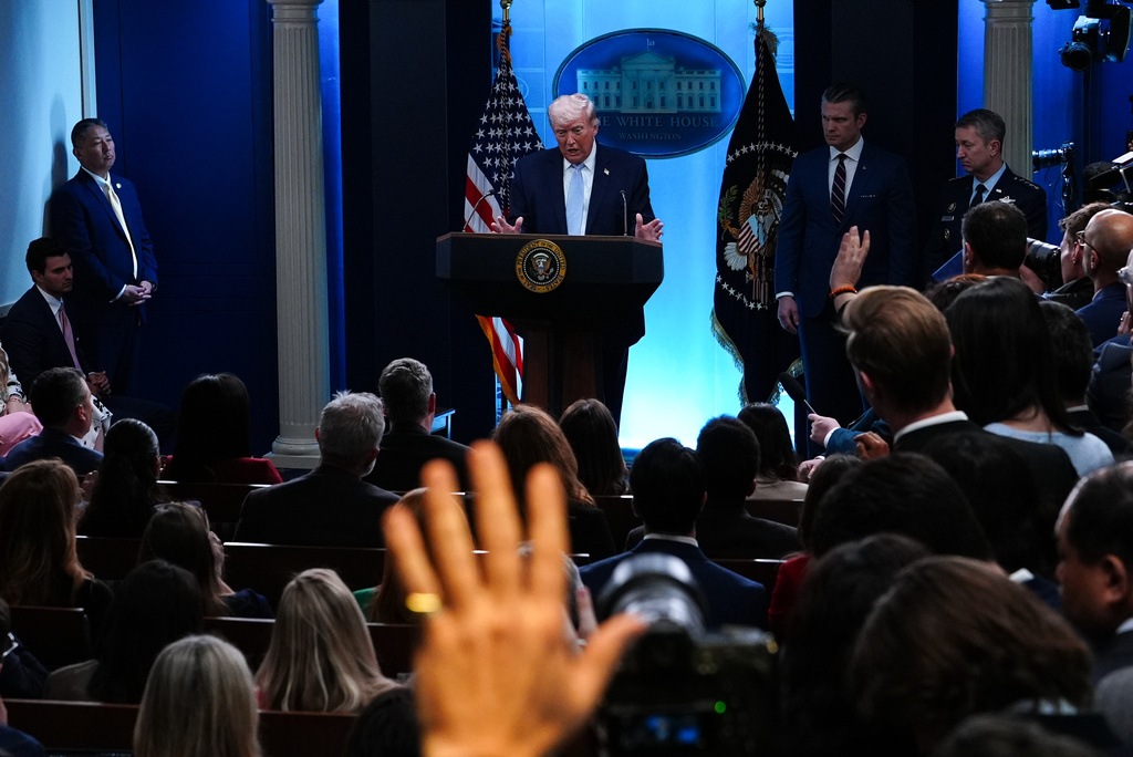 President Donald Trump, accompanied by Defense Secretary Pete Hegseth and Chairman of the Joint Chiefs of Staff Gen. Dan Caine, speaks with reporters in the James Brady Press Briefing Room at the White House, Monday, April 6, 2026, in Washington. (AP Photo/Julia Demaree Nikhinson)