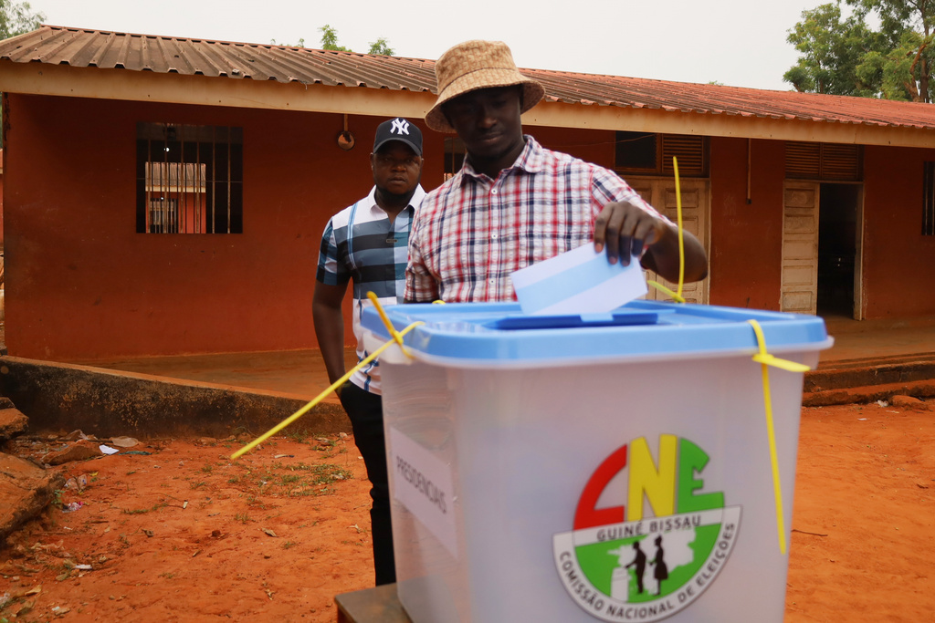 A man casts his vote during the Presidential and legislative elections, in Bissau, Guinea-Bissau, Sunday, Nov. 23, 2025. (AP Photo/Darcicio Barbosa)