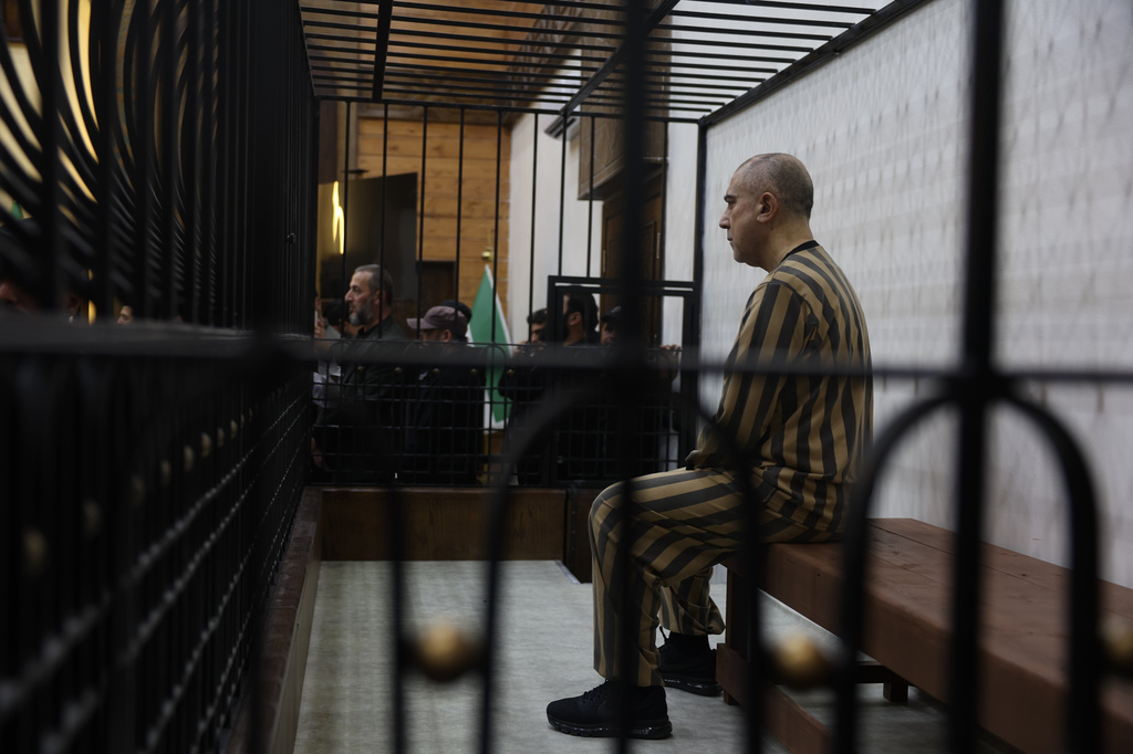 Atef Najib, former head of the Political Security Branch in the Daraa area during Bashar Assad's rule, sits in the defendants' cage during a trial session at the Palace of Justice in Damascus, Syria, Sunday, April 26, 2026. (AP Photo/Ghaith Alsayed)