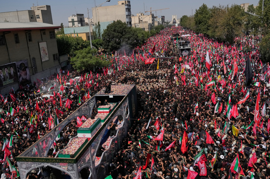 The truck carrying the coffins of the slain Iranian Supreme Leader Ayatollah Ali Khamenei and members of his family makes its way through mourners during the funeral procession toward Azadi Tower in Tehran, Iran, Monday, July 6, 2026. (AP Photo/Vahid Salemi)