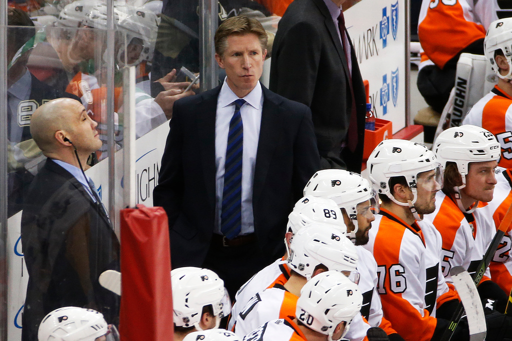 FILE - Philadelphia Flyers head coach Dave Hakstol, center, stands behind his bench during an NHL hockey game against the Pittsburgh Penguins in Pittsburgh, Thursday, Jan. 21, 2016. (AP Photo/Gene J. Puskar, File)