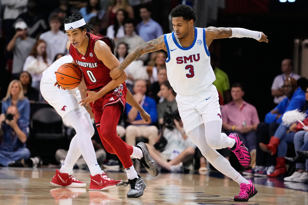 Louisville guard Mikel Brown Jr. (0) makes a steal as SMU's Corey Washington (3) defends during the first half of an NCAA college basketball game in Dallas, Tuesday, Feb. 17, 2026. (AP Photo/Tony Gutierrez)