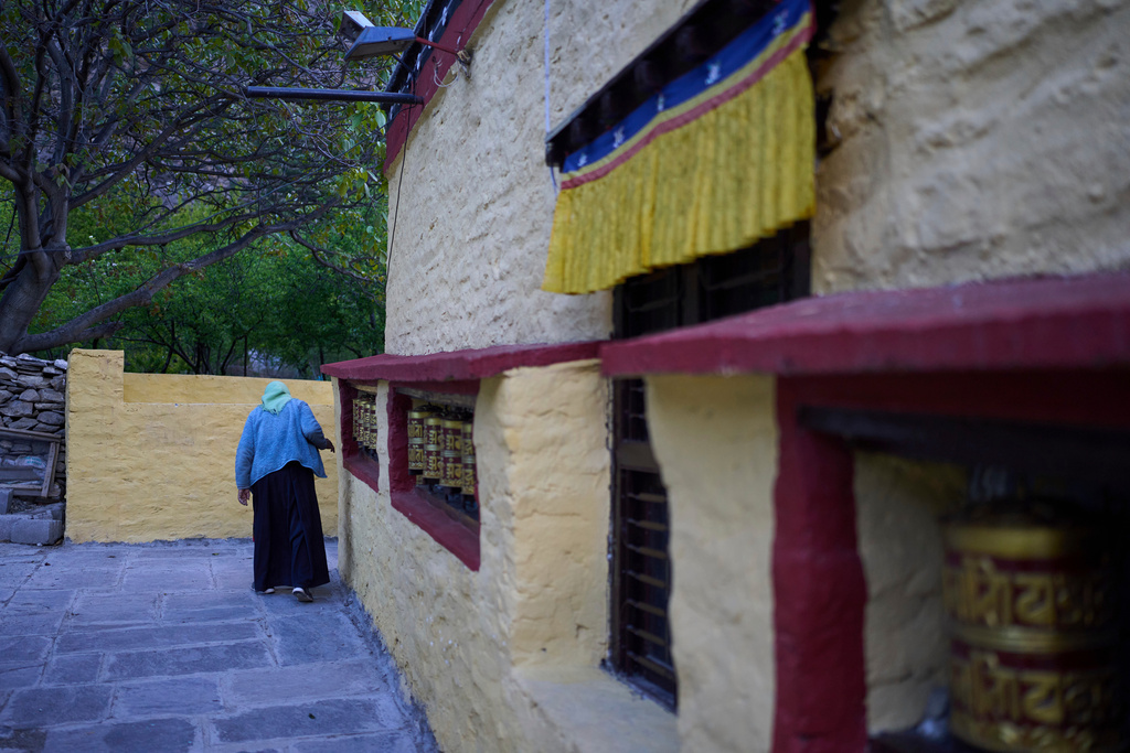 An elderly Tibetan exile walks near a monastery inside a Tibetan refugee camp in Mustang, Nepal, April 19, 2025. (AP Photo/Niranjan Shrestha)