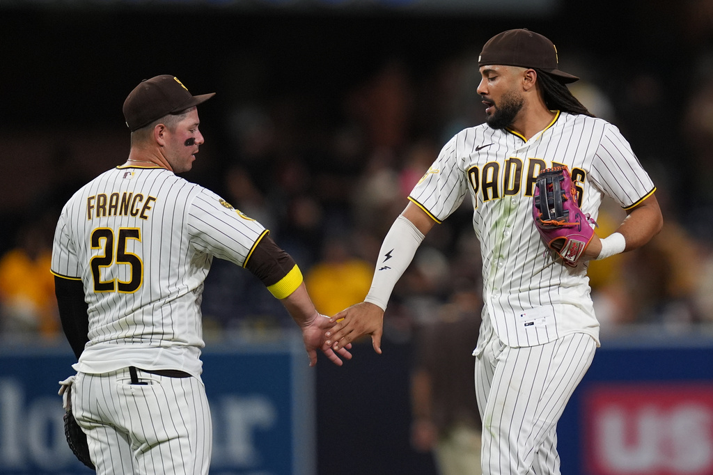 San Diego Padres right fielder Fernando Tatis Jr., right, celebrates with first baseman Ty France after the Padres defeated the Washington Nationals 5-4 in a baseball game Tuesday, Sept. 8, 2026, in San Diego. (AP Photo/Gregory Bull)