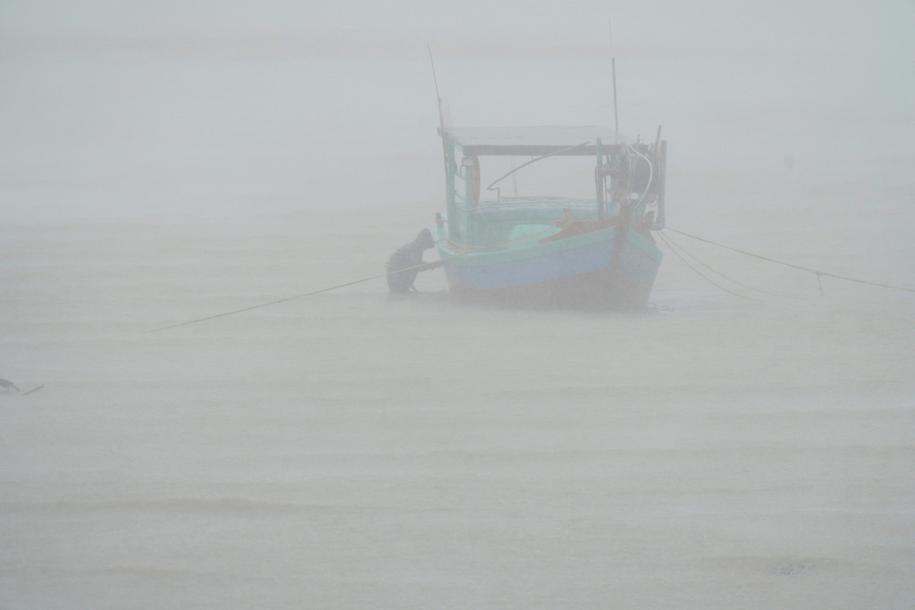 FILE- A fisherman checks his boat in the rain in Ha Tinh province, Vietnam, Aug. 25, 2025, as Typhoon Kajiki was approaching. (Nguyen Dong/VNExpress via AP, File)