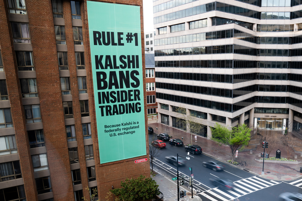 FILE - An advertisement for prediction market platform Kalshi hangs at 13th and L Streets in northwest Washington, April 1, 2026. (AP Photo/Allison Robbert, File)
