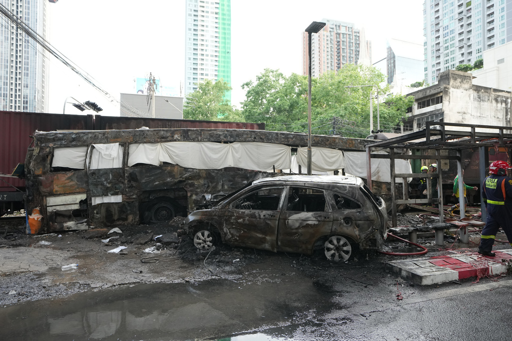 Damaged vehicles are seen at a train crash site near Makkasan station in Bangkok, Thailand, Saturday, May 16, 2026. (AP Photo/Sakchai Lalit)