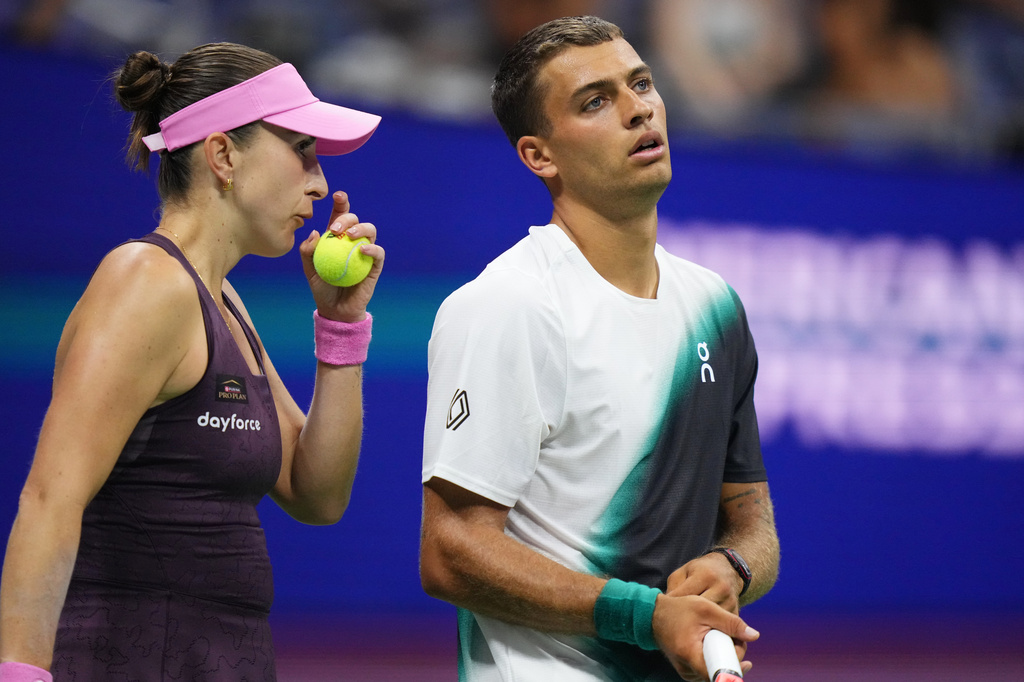 Belinda Bencic, left, of Switzerland, and Flavio Cobolli, of Italy, react while competing against Elina Svitolina, of Ukraine, and Gael Monfils, of France, during a mixed doubles semifinal match at the U.S. Open tennis championships Wednesday, Aug. 26, 2026, in New York. (AP Photo/Frank Franklin II)