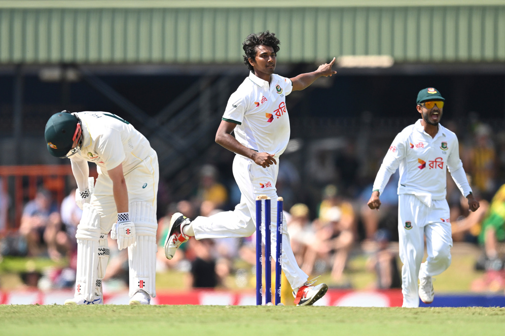 Hasan Mahmud, center, of Bangladesh reacts after dismissing Australia's Travis Head, left, during play on day three of the first cricket test in Darwin, Australia, Saturday, Aug. 15, 2026, (James Ross/AAPImage via AP)