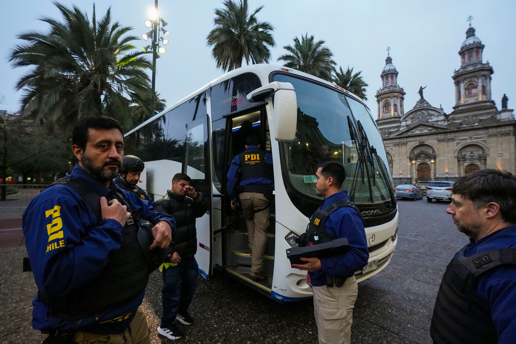 A migrant cries as he is boarded on a bus by Investigative Police agents during an immigration and security check at Plaza de Armas, following Chilean President José Antonio Kast's announcement of a new security agenda and stricter enforcement measures, in Santiago, Chile, Thursday, Aug. 6, 2026. (AP Photo/Esteban Felix)