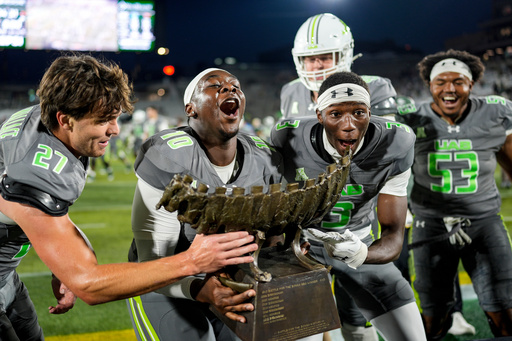 UAB players celebrate victory with the Battle for the Bones trophy after an NCAA college football game against Memphis, Saturday, Oct. 18, 2025, in Birmingham, Ala. (AP Photo/Mike Stewart) UAB players celebrate victory with the Battle for the Bones trophy after an NCAA college football game against Memphis, Saturday, Oct. 18, 2025, in Birmingham, Ala. (AP Photo/Mike Stewart)