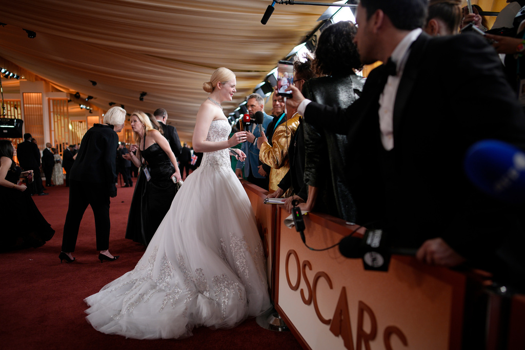 Elle Fanning, left, seen with Guillermo Rodriguez as she arrives at the Oscars on Sunday, March 15, 2026, at the Dolby Theatre in Los Angeles. (AP Photo/John Locher)