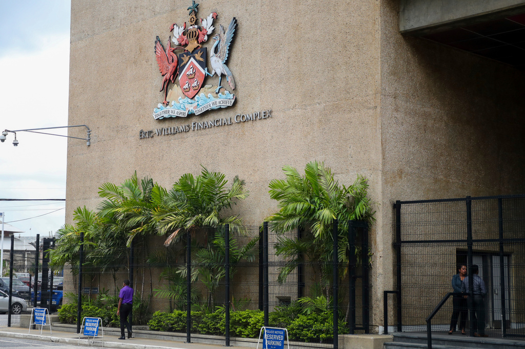 FILE - The country's coat of arms hangs on the facade of a government building in Port-of-Spain, Trinidad and Tobago, Aug. 20, 2024. (AP Photo/Ash Allen, File)