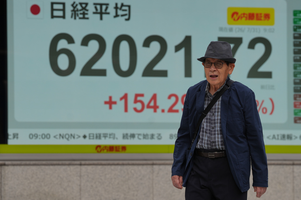 A person walks past an electronic board showing Japan's Nikkei index at a securities firm Friday, July 31, 2026. (AP Photo/Eugene Hoshiko)