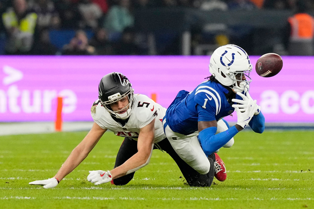 Indianapolis Colts cornerback Sauce Gardner (1) breaks up a pass intended for Atlanta Falcons wide receiver Drake London (5) during the second half of an NFL football game, Sunday, Nov. 9, 2025, in Berlin, Germany. (AP Photo/Martin Meissner)
