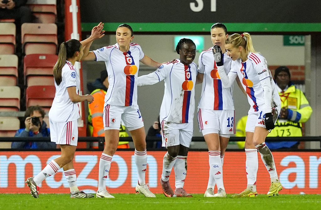 OL Lyonnes' Tabitha Chawinga, center, celebrates with teammates after scoring their side's first goal during a women's Champions League soccer match against Manchester United, Wednesday, Dec. 10, 2025, in Leigh, England. (Martin Rickett/PA via AP)