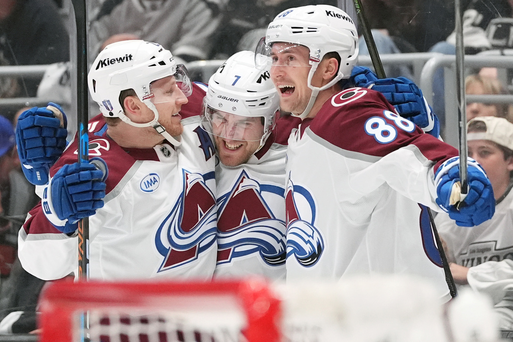 Colorado Avalanche's Devon Toews (7) celebrates his goal with Nathan MacKinnon (29) and Martin Necas (88) against the Los Angeles Kings during the third period of Game 4 in the first round of an NHL hockey Stanley Cup playoff series Sunday, April 26, 2026, in Los Angeles. (AP Photo/Scott Strazzante)