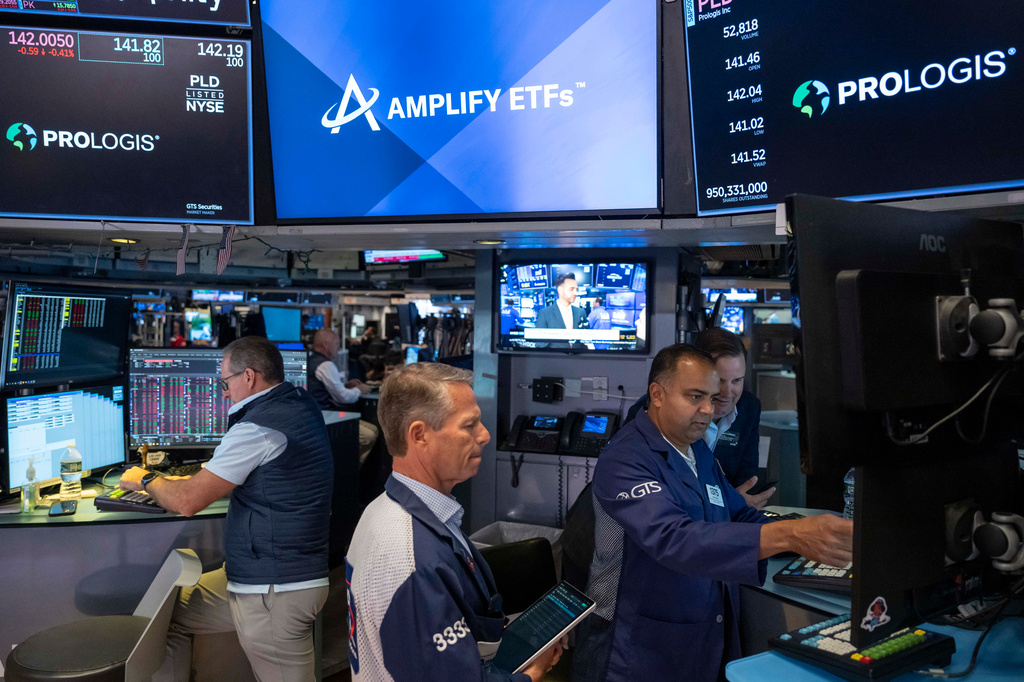 Specialists Dilip Patel, right, and Trader Robert Charmak, center, work on the floor of the New York Stock Exchange, Thursday, Aug. 27, 2026, in New York. (AP Photo/Yuki Iwamura)