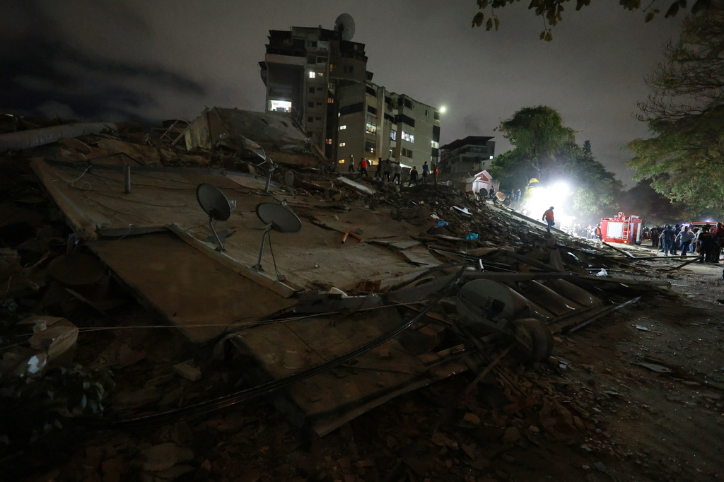 Rescue workers search through the rubble of a collapsed building after an earthquake in Caracas, Venezuela, Wednesday, June 24, 2026. (AP Photo/Javier Campos)