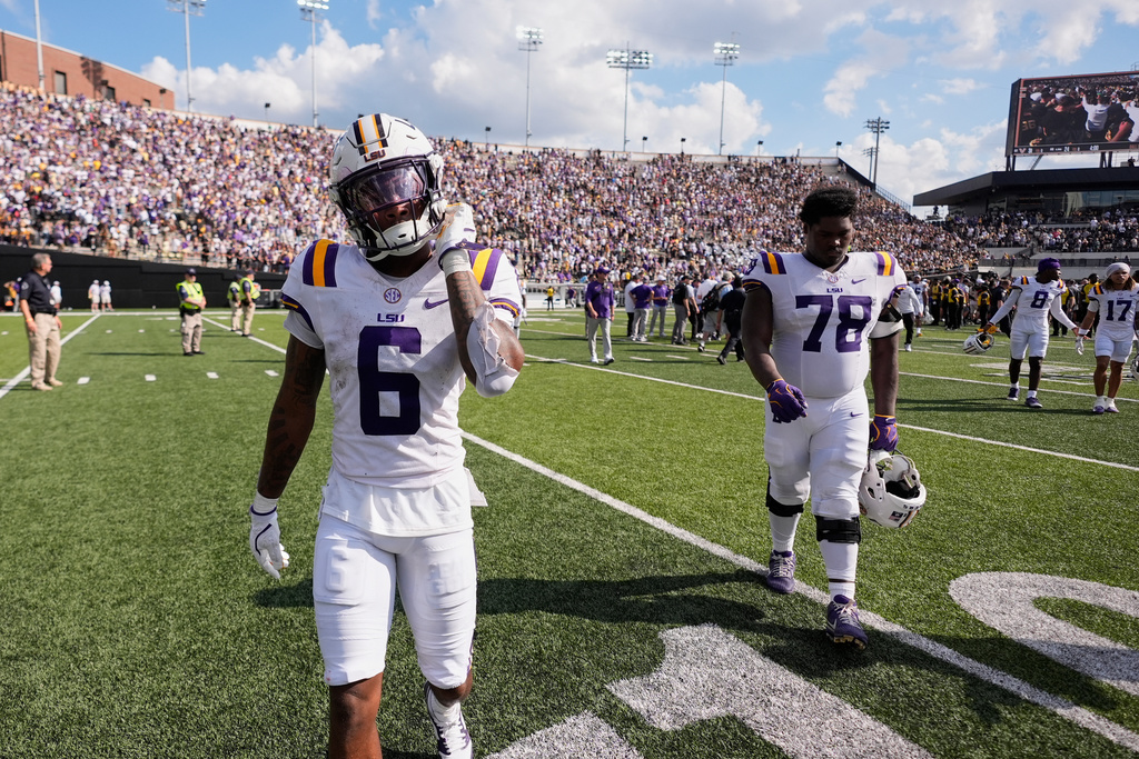 LSU wide receiver Barion Brown (6) and offensive lineman Coen Echols (78) walk off the field after the team's loos in an NCAA college football game against Vanderbilt, Saturday, Oct. 18, 2025, in Nashville, Tenn. (AP Photo/George Walker IV)