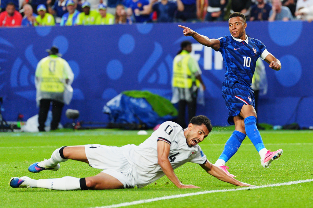 France's Kylian Mbappe (10) celebrates after scoring their second goal as Iraq's Zaid Tahseen (4) reacts during the World Cup Group I soccer match between France and Iraq in Philadelphia, Monday, June 22, 2026. (AP Photo/Derik Hamilton)
