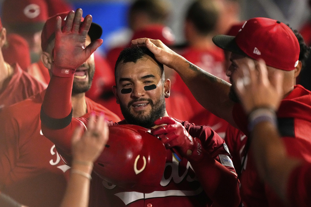 Cincinnati Reds' Jose Trevino is congratulated by teammates in the dugout after scoring on sacrifice by TJ Friedl during the ninth inning of a baseball game against the Los Angeles Angels, Tuesday, Aug. 19, 2025, in Anaheim, Calif. (AP Photo/Mark J. Terrill)