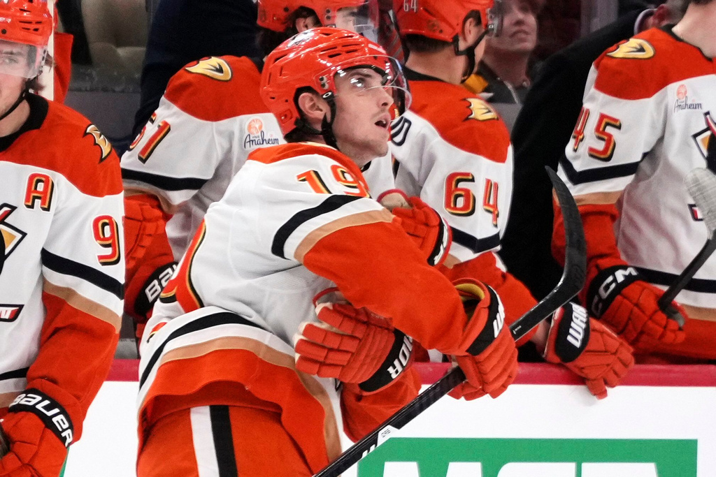 Anaheim Ducks' Troy Terry (19) looks at the replay of his goal as he returns to the bench after scoring during the second period of an NHL hockey game against the Pittsburgh Penguins in Pittsburgh, Tuesday, Dec. 9, 2025. (AP Photo/Gene J. Puskar)