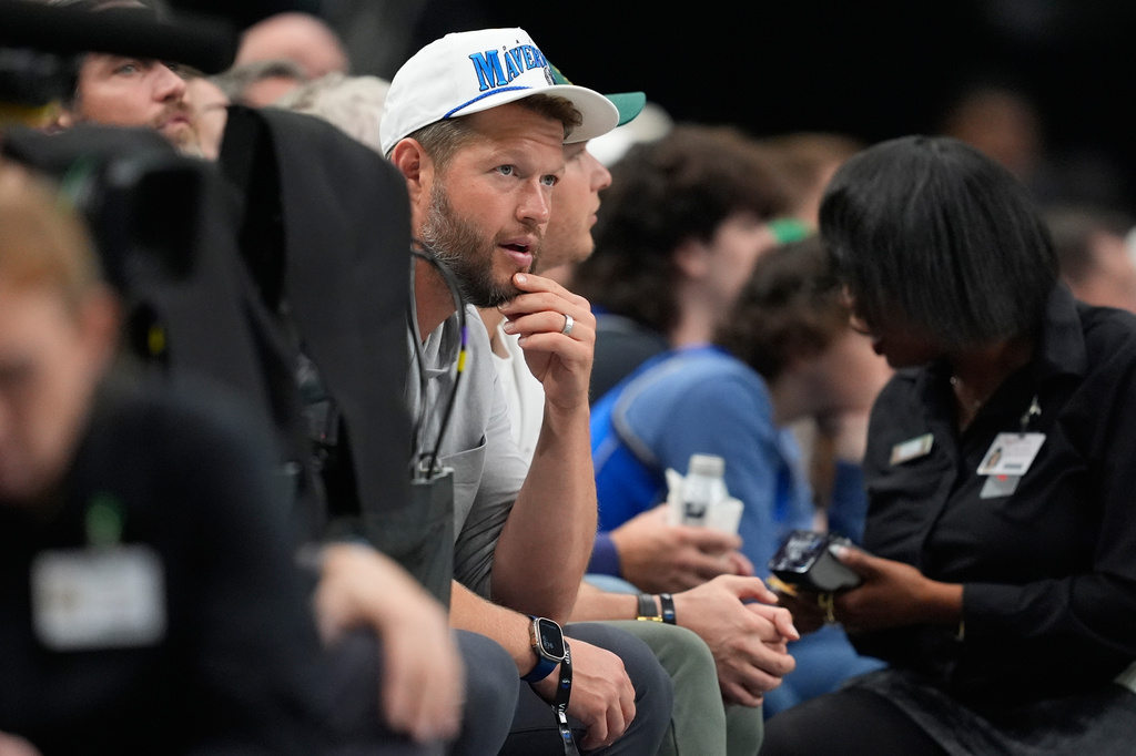 Retired Los Angels Dodgers pitcher Clayton Kershaw looks on during the first half of an NBA basketball game between the New York Knicks and Dallas Mavericks Wednesday, Nov. 19, 2025, in Dallas. (AP Photo/Tony Gutierrez)