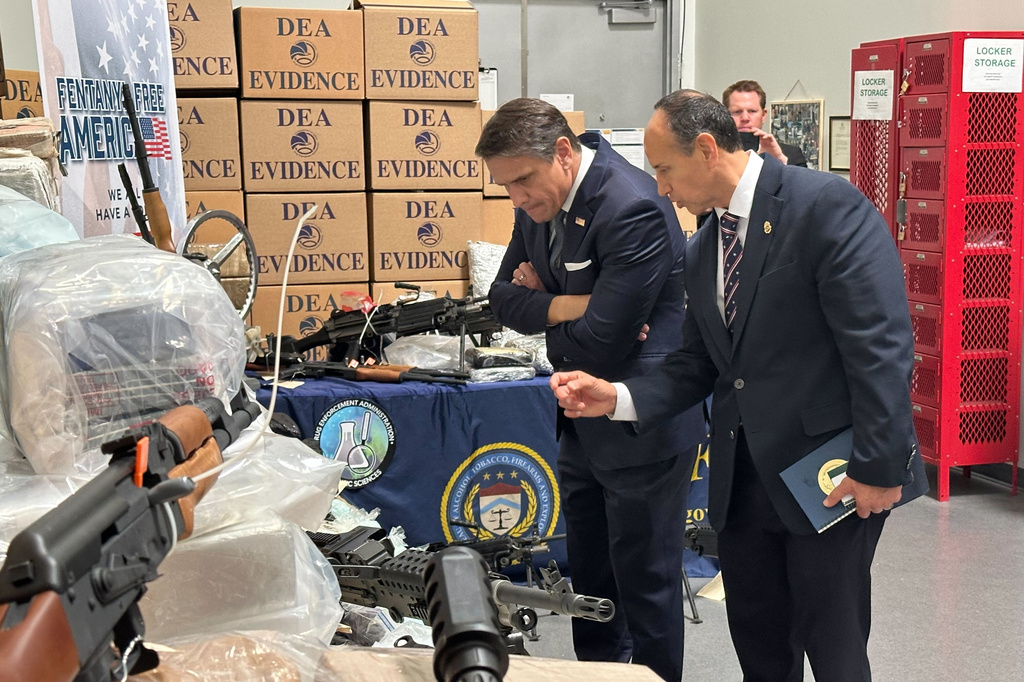 Acting Attorney General Todd Blanche looks at weapons and drugs that were seized by federal officers, with Drug Enforcement Administration special agent in charge Apolonio Ruiz, Jr., at a warehouse in Phoenix, Wednesday, May 6, 2026. (AP Photo/Rebecca Santana)