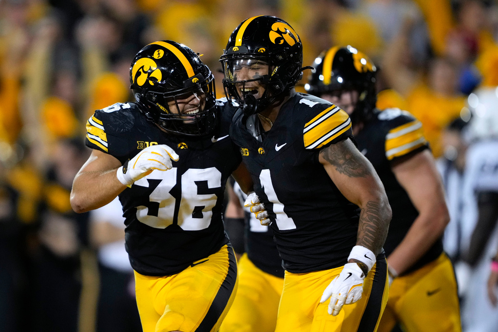Iowa defensive back Xavier Nwankpa (1) celebrates with teammate Jayden Montgomery (36) after intercepting a pass during the first half of an NCAA college football game against Penn State, Saturday, Oct. 18, 2025, in Iowa City, Iowa. (AP Photo/Charlie Neibergall)