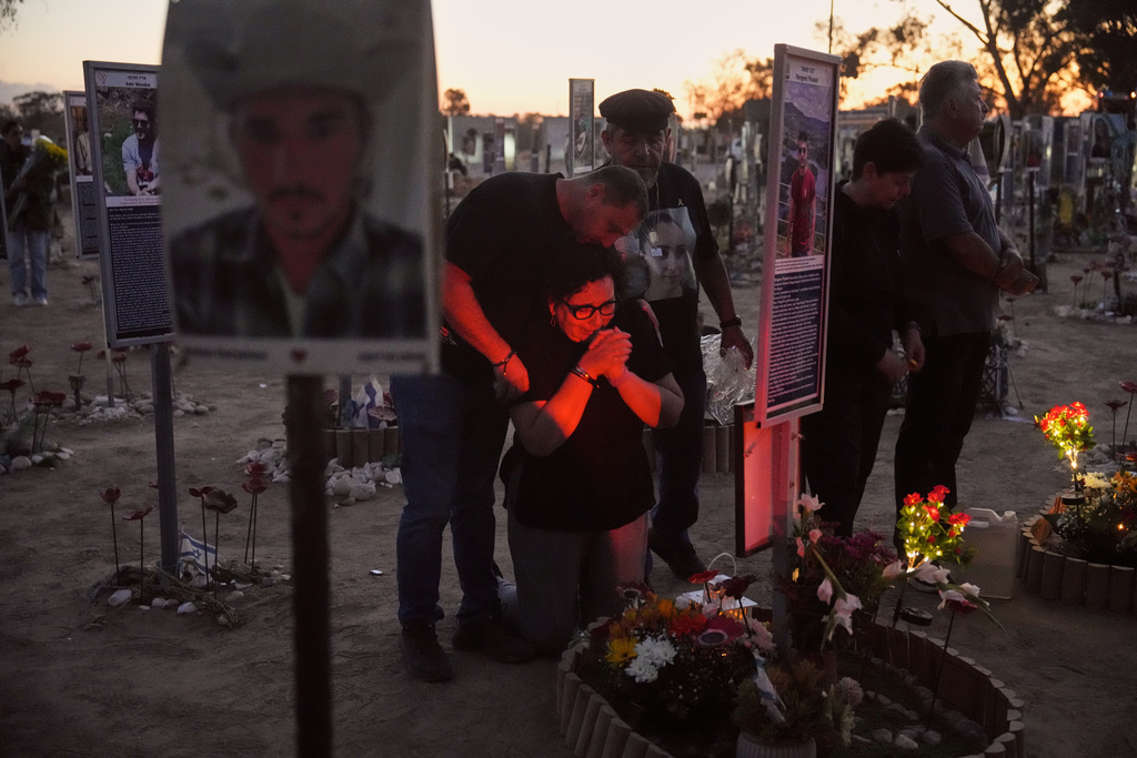People visit the site of the Nova music festival, where hundreds of revelers were killed and abducted by Hamas and taken into Gaza, as Israel marks the second year anniversary of the attack, near Kibbutz Reim, southern Israel, Tuesday, Oct. 7, 2025. (AP Photo/Ariel Schalit)