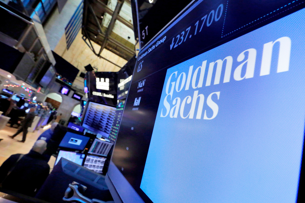 FILE - In this Dec. 13, 2016, file photo, the logo for Goldman Sachs appears above a trading post on the floor of the New York Stock Exchange. (AP Photo/Richard Drew, File)