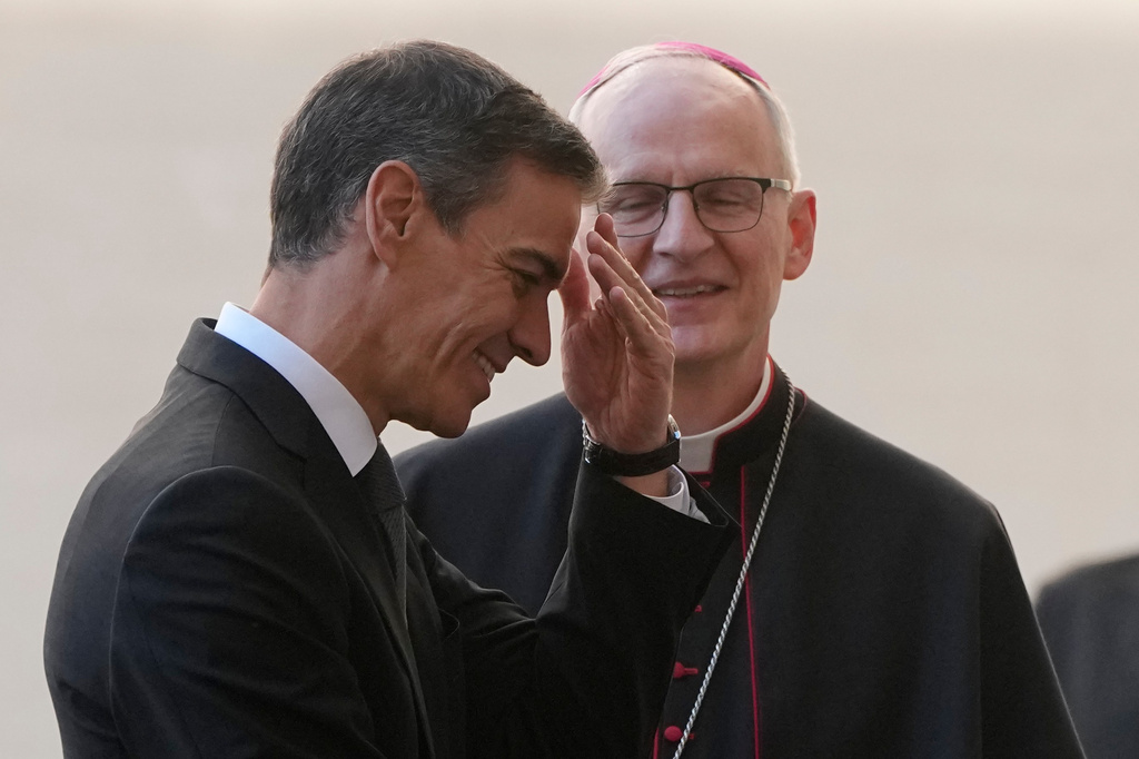 Spain's Premier Pedro Sanchez is welcomed by Archbishop Petar Rajic, Prefect of the Prefecture of the Papal Household as he arrives at the St. Damasus courtyard ahead of their private audience with Pope Leo XIV at the Vatican, Wednesday, May 27, 2026. (AP Photo/Alessandra Tarantino)