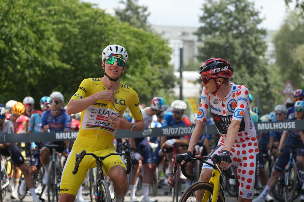 Slovenia's Tadej Pogacar, wearing the overall leader's yellow jersey, and Denmark's Jonas Vingegaard, wearing the best climber's dotted jersey, get ready for the fourteenth stage of the Tour de France cycling race with the start in Mulhouse and the finish in Le Markstein Fellering, France, Saturday, July 18, 2026. (AP Photo/Thibault Camus)