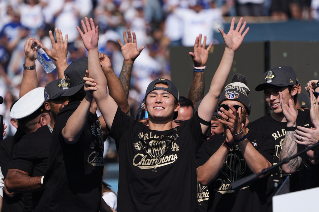 Los Angeles Dodgers' Yoshinobu Yamamoto waves during a celebration of the baseball team's World Series win at Dodger Stadium on Monday, Nov. 3, 2025, in Los Angeles. (AP Photo/Gregory Bull)