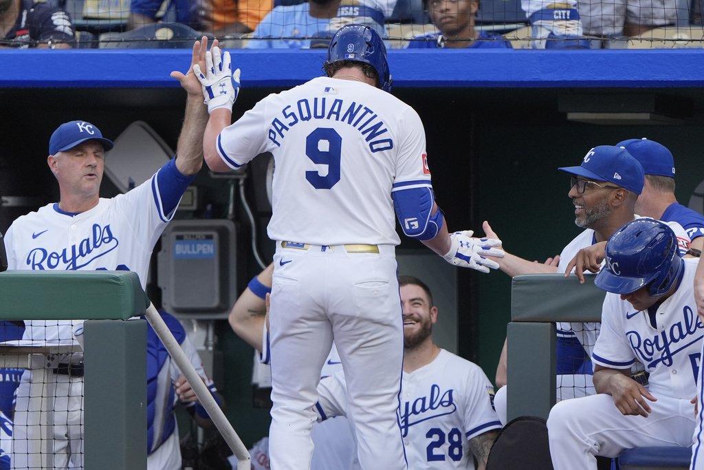 Kansas City Royals' Vinnie Pasquantino celebrates with teammates after hitting a solo home run during the first inning of a baseball game against the Texas Rangers, Tuesday, Aug. 19, 2025, in Kansas City, Mo. (AP Photo/Charlie Riedel)