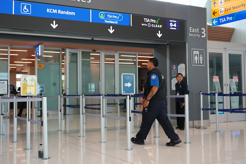 A Transportation Security Administration worker heads into the east security checkpoint in Denver International Airport Thursday, Oct. 2, 2025, in Denver. (AP Photo/David Zalubowski)