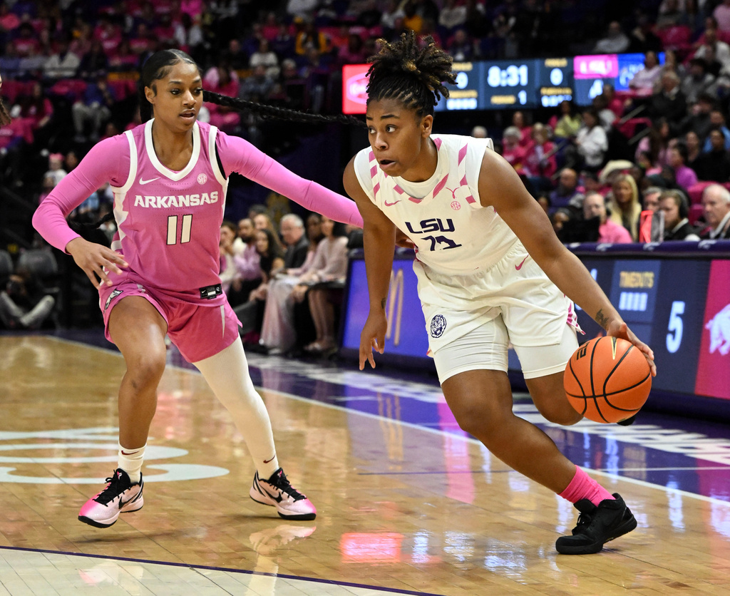 LSU guard Mikaylah Williams, right, drives the ball around Arkansas guard Wyvette Mayberry (11) during an NCAA college basketball game Thursday, Jan. 29, 2026, in Baton Rouge, La. (Hilary Scheinuk/The Advocate via AP)