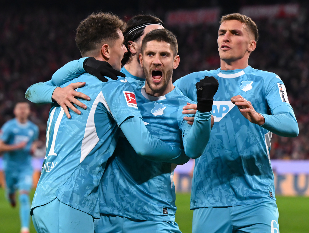 Hoffenheim's Andrej Kramaric, center, celebrates scoring with teammates during the Bundesliga soccer match between Bayern Munich and TSG 1899 Hoffenheim in Munich, Germany, Sunday Feb. 8, 2026. (Sven Hoppe/dpa via AP)