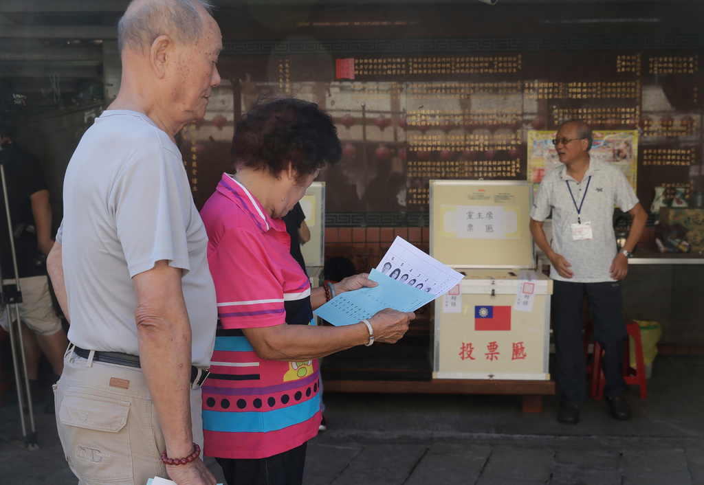 Members of Taiwan's Nationalist Party, or Kuomintang (KMT) vote for the party's leadership race at a polling station in Taipei, Taiwan, Saturday, Oct. 18, 2025. (AP Photo/Chiang Ying-ying)