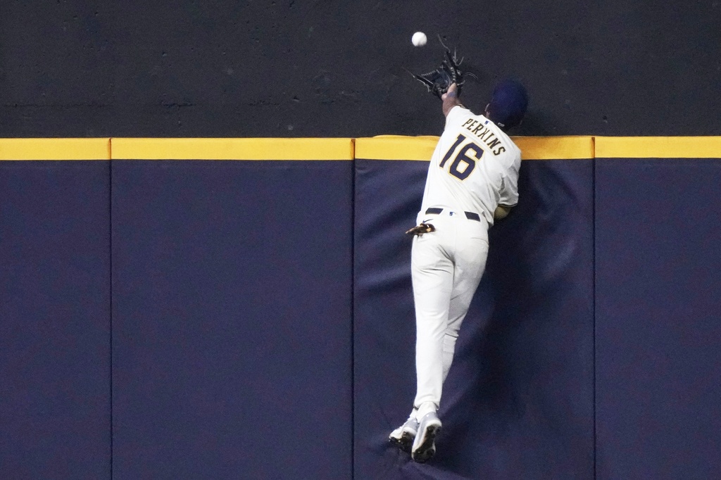 Milwaukee Brewers' Blake Perkins can't catch a home run hit by Los Angeles Angels' Denzer Guzman during the fifth inning of a baseball game Tuesday, Sept. 16, 2025, in Milwaukee. (AP Photo/Morry Gash)