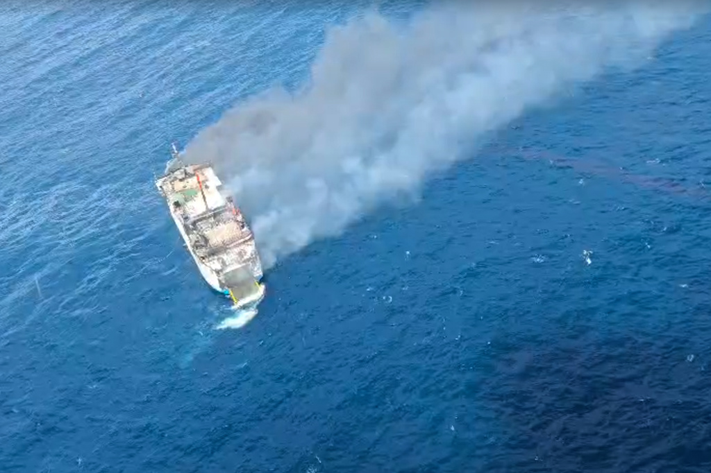 In this photo made from video released by the Indonesian National Search and Rescue Agency (BASARNAS), smoke billows from a passenger ferry Putri Yasmin after it caught fire while traveling from the tourist island of Bali to neighboring island of Lombok, in the waters of Lombok Strait, Indonesia, Wednesday, Aug. 12, 2026. (BASARNAS via AP)