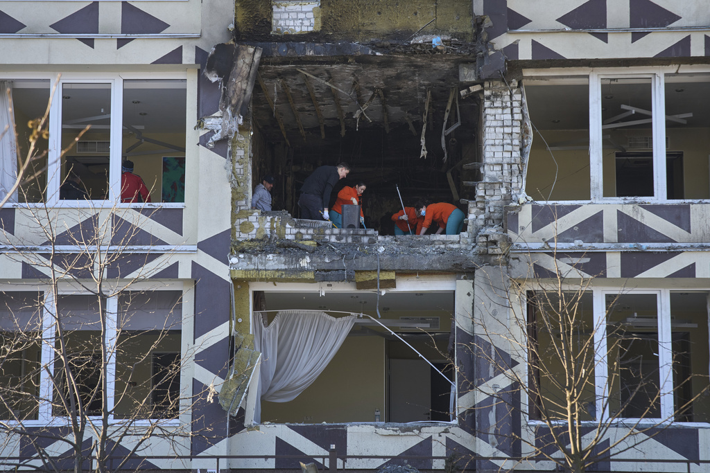 Medical workers remove the debris in a damaged private clinic after, according to Ukrainian officials, a Russian drone hit a hospital room killing a patient, in Kyiv, Ukraine, Monday, Jan 5, 2026. (AP Photo/Efrem Lukatsky)