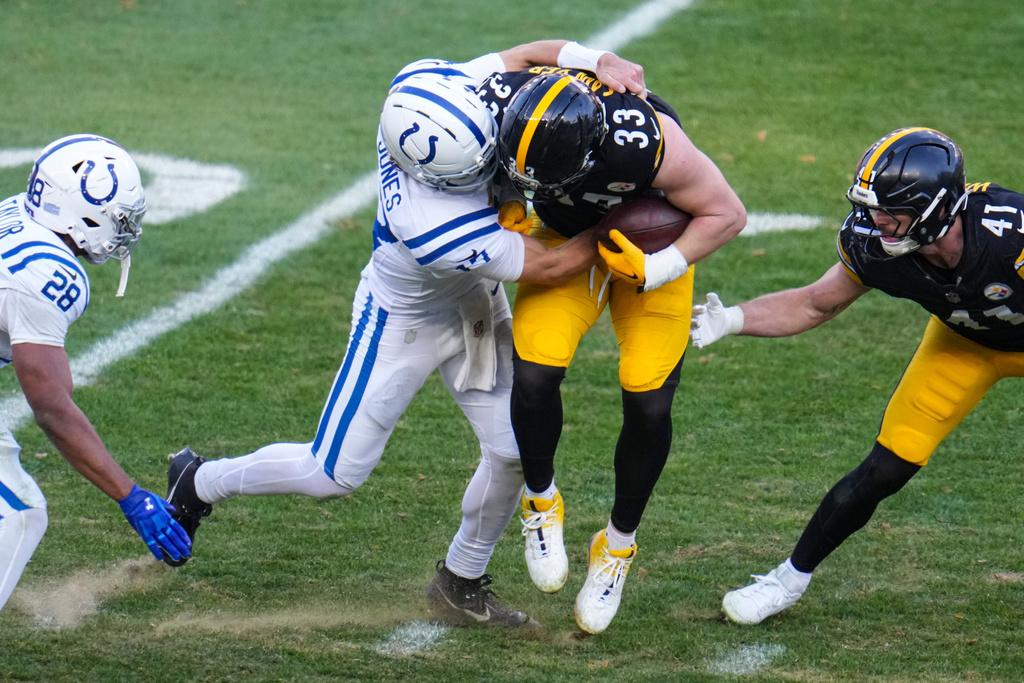 Pittsburgh Steelers linebacker Jack Sawyer (33) is tackled by Indianapolis Colts quarterback Daniel Jones (17) after an interception during the second half of an NFL football game in Pittsburgh, Sunday, Nov. 2, 2025. (AP Photo/Gene J. Puskar)