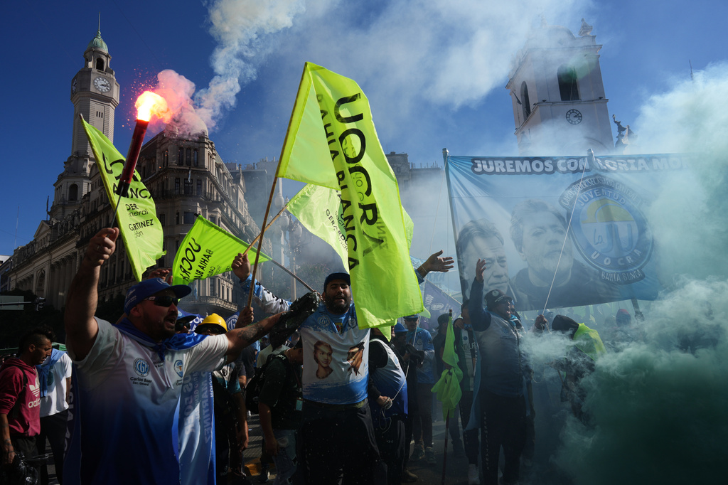 Laborers hold flares during a May Day demonstration in Buenos Aires, Argentina, Thursday, April 30, 2026. (AP Photo/Rodrigo Abd)