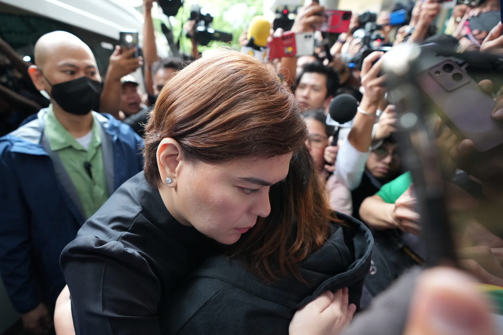 Philippine Vice President Sara Duterte embraces a supporter after posting bail at the Quezon city justice hall, Philippines, Saturday, Sept. 5, 2026, after a warrant of arrest on charges that she publicly threatened to arrange the assassination of President Ferdinand Marcos Jr. and two other people. (AP Photo/Aaron Favila)